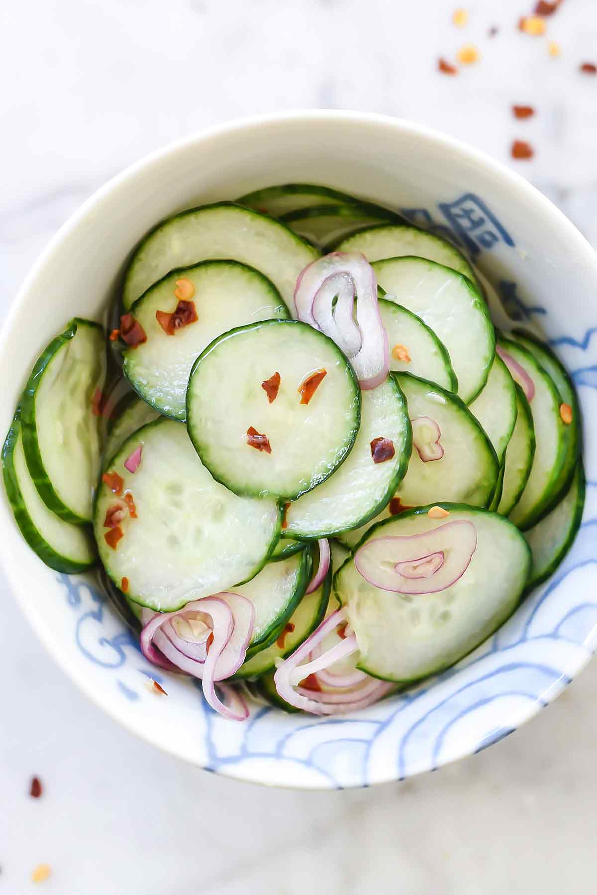 Two fresh green mini cucumbers and sliced half with three slices